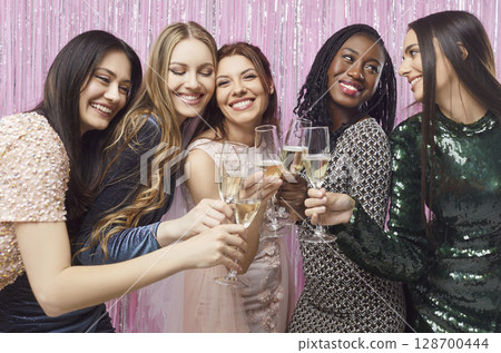 Happy funny beautiful multiracial friends girls, bride drinking champagne, women have hen party Happy funny beautiful multiracial friends girls, bride drinking champagne, women have hen party 128700444