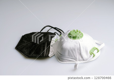 ffp2 and ffp3 protective face mask on a light background, closeup 128700466