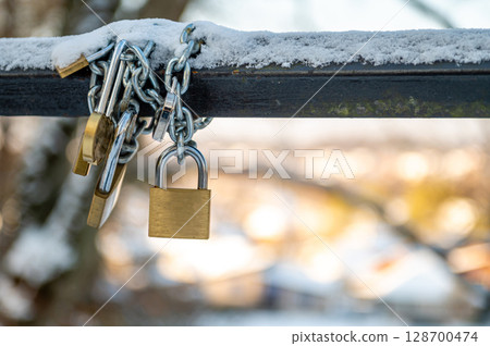 Traditional locks of lovers on the bridge. Symbol of love and fidelity Traditional locks of lovers on the bridge. Symbol of love and fidelity 128700474