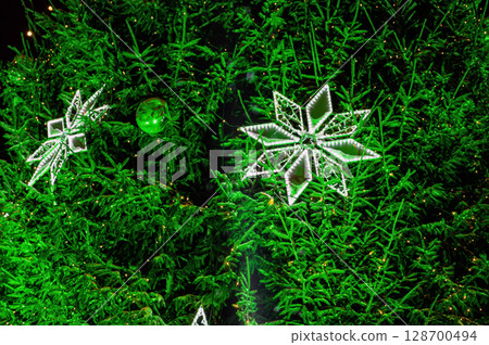 Christmas outdoor background with fir tree branches and Lights blurred bokeh. 128700494