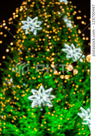 garland of light bulbs on defocused festive lights background, shallow depth of field, copy space garland of light bulbs on defocused festive lights background, shallow depth of field, copy space 128700497