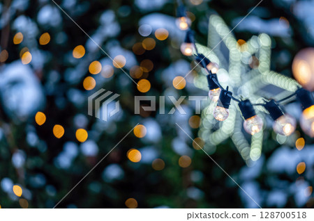 garland of light bulbs on defocused festive lights background, shallow depth of field, copy space garland of light bulbs on defocused festive lights background, shallow depth of field, copy space 128700518