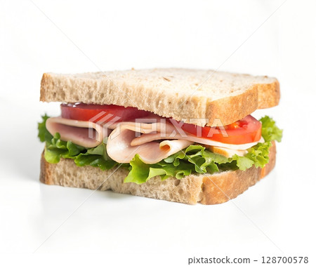 Deliciously crafted turkey sandwich with fresh lettuce, ripe tomato slices, and cheese on whole wheat bread 128700578