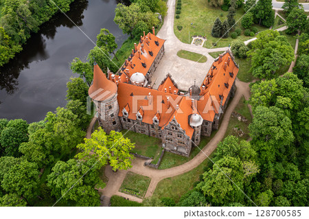 Cesvaine medieval castle in Latvia from above. Building of stones with a brown tiled roof. 128700585