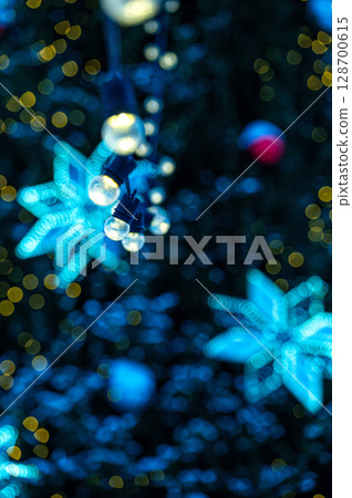 Christmas tree with garlands lights and bokeh copy space. Outdoor winter holiday atmosphere. Christmas tree with garlands lights and bokeh copy space. Outdoor winter holiday atmosphere. 128700615
