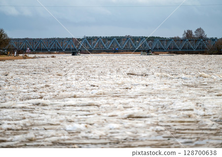 A huge load of ice in the Lielupe river near the railway bridge in Jelgava A huge load of ice in the Lielupe river near the railway bridge in Jelgava 128700638