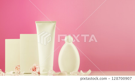 Mock up of natural beauty products based on rose flowers. White cosmetic tube and bottle with white boxes on pink gradient background with tender roses and rose petals. Soft focus style, copy space 128700907