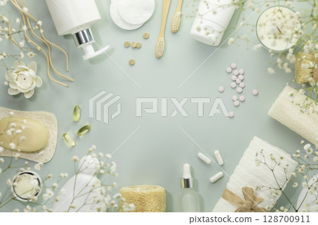 Eco friendly spa relax composition with beauty products, serums, soap, accessories and supplements on blue background. Wellness and skin care treatment. Concept of me time and self care. Copy space 128700911