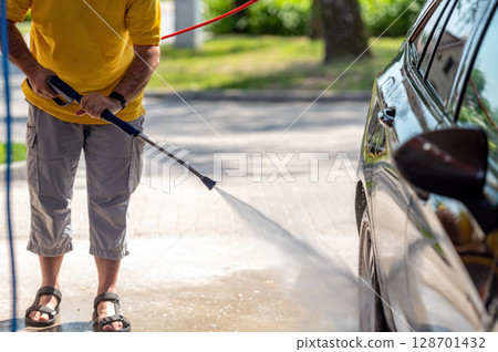 Manual wash for perfect clean car. Cleaning car using high pressure water. Manual wash for perfect clean car. Cleaning car using high pressure water. 128701432