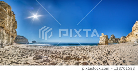 Wide beach view with cliffs and sunlight Algarve Wide beach view with cliffs and sunlight Algarve 128701588