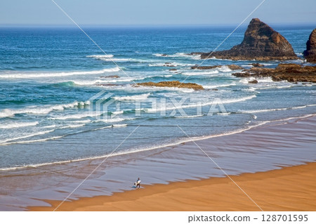 Surfer on empty beach in Alentejo Portugal Surfer on empty beach in Alentejo Portugal 128701595