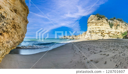 Secluded beach with cliffs and soft waves Algarve Secluded beach with cliffs and soft waves Algarve 128701607