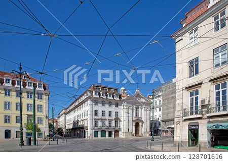 Church and tram wires in Lisbon street 128701616