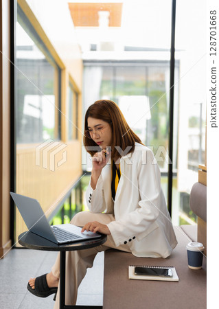 Female business clicking internet search page on computer touch screen in office. 128701668