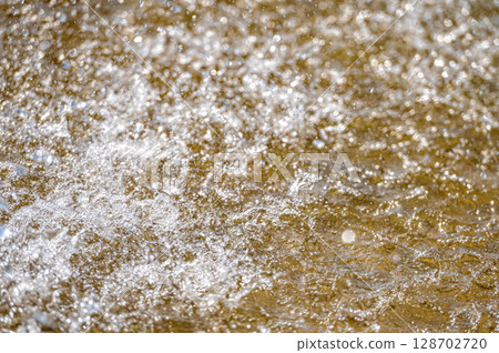 Water splash with small drops in the fountain. Abstract natural, selective focus, copy space Water splash with small drops in the fountain. Abstract natural, selective focus, copy space 128702720