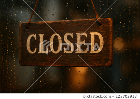 Vintage Wooden Closed Sign Hanging on Weathered Door Indicating Temporary Business Shutdown 128702918