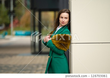 elegantly dressed business woman at an office building in a financial district 128703061