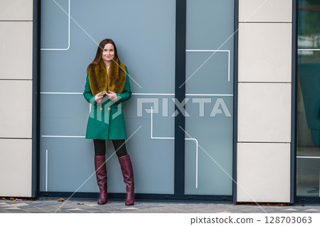 portrait of an elegantly dressed business woman at a glazed building in a financial district portrait of an elegantly dressed business woman at a glazed building in a financial district 128703063