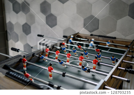 table football with figures of players in red and blue uniforms. table football with figures of players in red and blue uniforms. 128703235