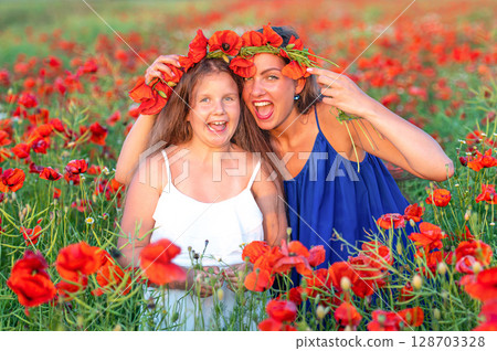 elegant young woman with child girl in poppy field, happy family having fun in nature, summer time elegant young woman with child girl in poppy field, happy family having fun in nature, summer time 128703328