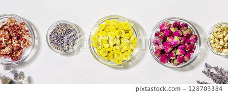 Home herbal apothecary concept. Sustainable banner with different kind of dry flowers and herbs on white background. Healing wild plants and flowers. Banner size, Flat lay 128703384