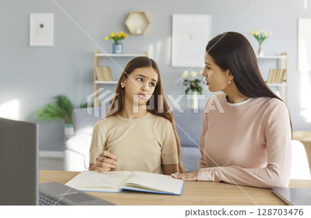 Sad Daughter And Mother Doing Homework And Having Conflict At Home Sad Daughter And Mother Doing Homework And Having Conflict At Home 128703476