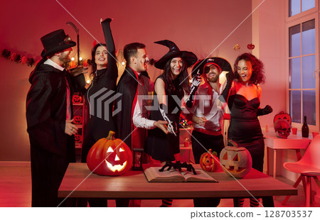 Happy Halloween party fun, friends group cosplay costume amuse, pumpkin decor, scary people in black 128703537