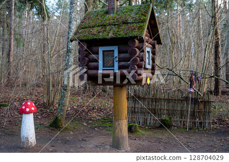A hut on chicken legs stands in a fairy-tale, magical forest 128704029