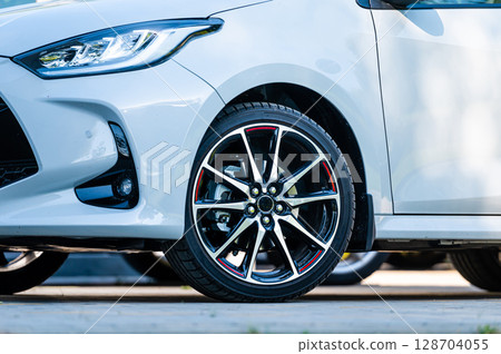 sports car wheels, low profile tires on aluminum rims, closeup 128704055