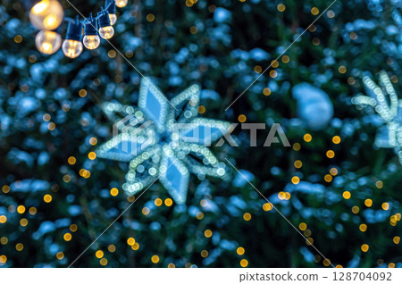 garland of light bulbs on defocused festive lights background, shallow depth of field, copy space garland of light bulbs on defocused festive lights background, shallow depth of field, copy space 128704092