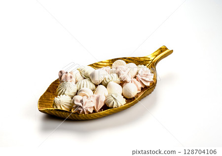 decorative dish with meringue cookies from egg whites, selective focus, closeup, copy space decorative dish with meringue cookies from egg whites, selective focus, closeup, copy space 128704106