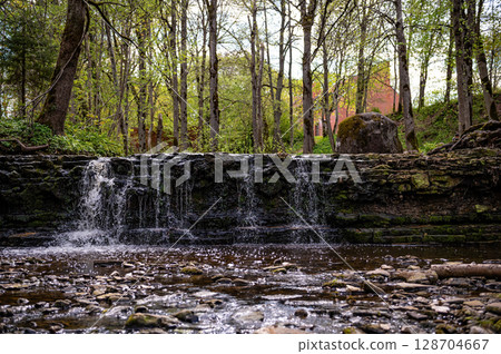 beautiful view in spring of a waterfall on small river Ivande in Latvia 128704667