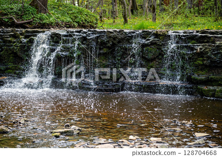 beautiful view in spring of a waterfall on small river Ivande in Latvia beautiful view in spring of a waterfall on small river Ivande in Latvia 128704668