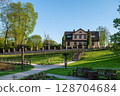 Kuldiga Old Town Park with walking paths and adjacent buildings, Kuldiga, Latvia 128704684