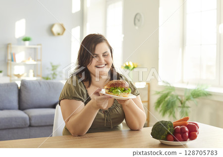 Obese hungry woman with excessive fat eating, choosing unhealthy fast food instead vegetables Obese hungry woman with excessive fat eating, choosing unhealthy fast food instead vegetables 128705783