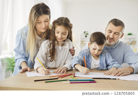 Loving family hobby, mother, father at home have fun painting with cute kids together in album Loving family hobby, mother, father at home have fun painting with cute kids together in album 128705805