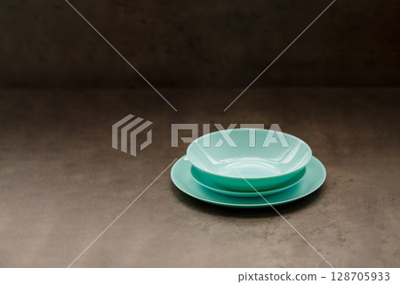 blue plates of different sizes and shapes on a gray background 128705933