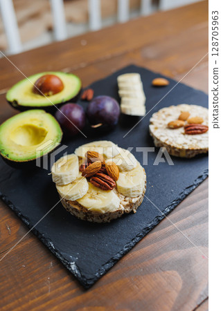 Vegan rice bread for breakfast with avocado and plums. Healthy Eating. Vegan rice bread for breakfast with avocado and plums. Healthy Eating. 128705963