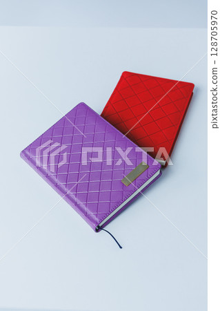 A leather wallet and a notebook lie on the table. Small women's handbag 128705970