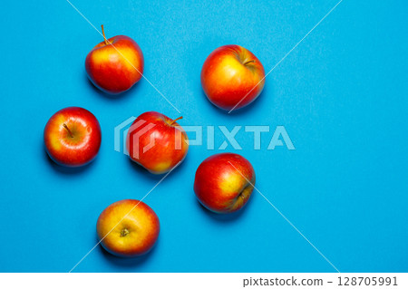 red-yellow juicy apples on a blue background. Healthy Nutrition and Vitamins red-yellow juicy apples on a blue background. Healthy Nutrition and Vitamins 128705991