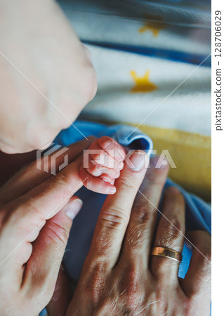 Newborn baby's hand close-up. A child's hand with a small palm Newborn baby's hand close-up. A child's hand with a small palm 128706029