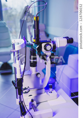 A modern microscope for vision testing in a light room. Microscope for vision correction. 128706032