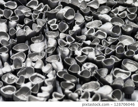 Innovative 3D printing process creates intricate metallic structures in a workshop environment 128706046