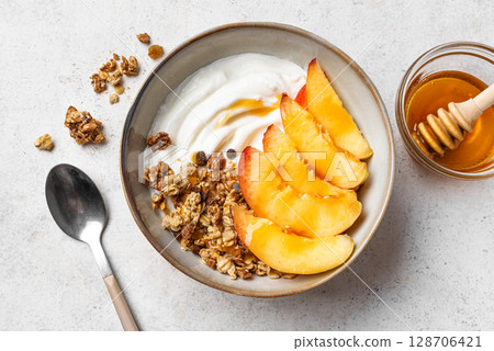 Granola bowl with greek yogurt, peach and honey Granola bowl with greek yogurt, peach and honey 128706421