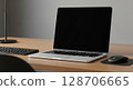 Modern laptop computer on a light wooden desk with keyboard and mouse. 128706665