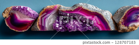 Polished magenta agate geode with exposed amethyst crystals and concentric banding 128707183