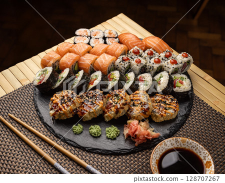 Assorted sushi arranged on a slate platter Assorted sushi arranged on a slate platter 128707267