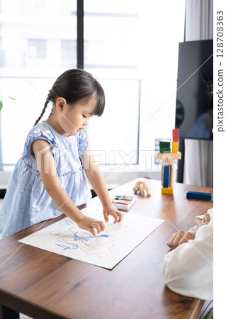 Educational scene of a girl enjoying drawing with crayons Educational scene of a girl enjoying drawing with crayons 128708363