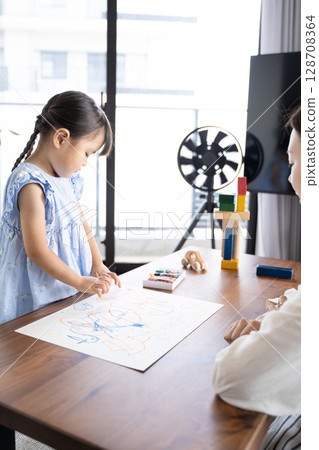 Educational scene of a girl enjoying drawing with crayons Educational scene of a girl enjoying drawing with crayons 128708364