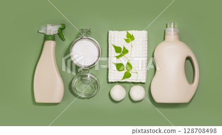 Natural laundry detergent mockup. Eco friendly washing concept with bottles of washing gel, fabric softener and stain remover, washing powder and laundry balls on a green background. Laundry day Natural laundry detergent mockup. Eco friendly washing concept with bottles of washing gel, fabric softener and stain remover, washing powder and laundry balls on a green background. Laundry day 128708498